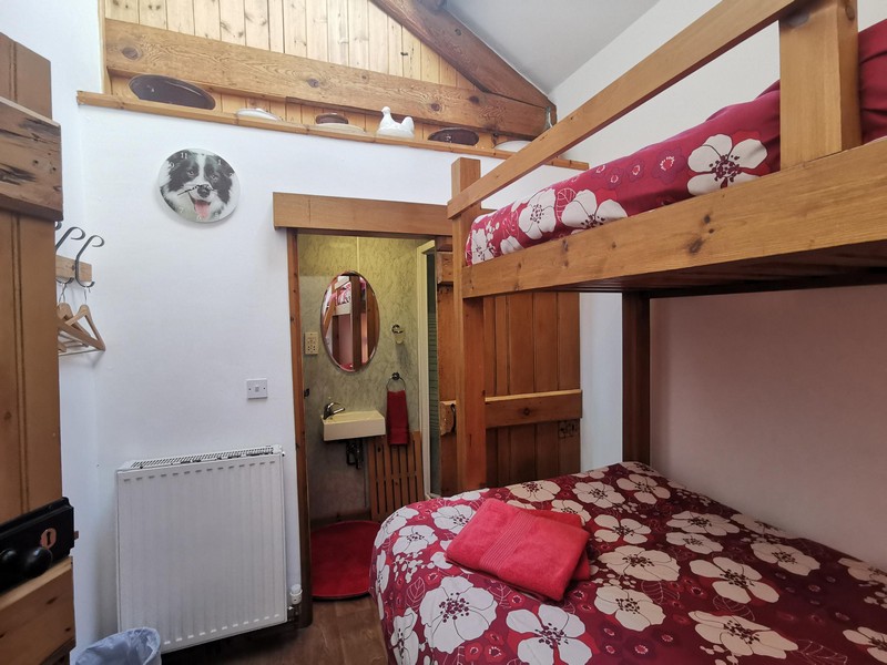 Bunk beds in the bunkhouse with radiator, hanging space and separate ensuite toilet and sink
